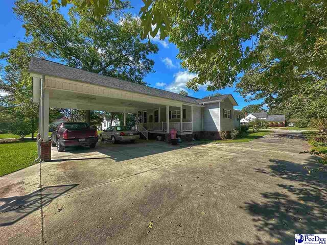 view of front of property with a carport and a porch