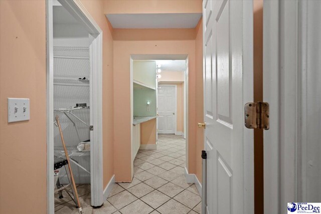 hallway featuring light tile patterned floors