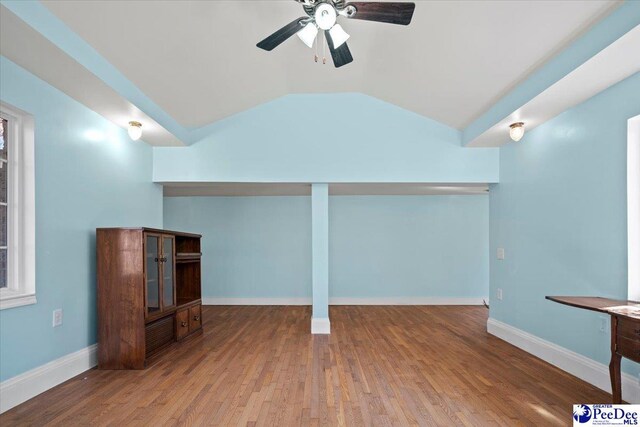 interior space with ceiling fan, wood-type flooring, and vaulted ceiling