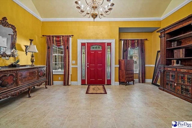 entryway with a notable chandelier, vaulted ceiling, and ornamental molding