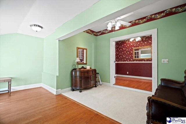 sitting room featuring wood-type flooring and lofted ceiling