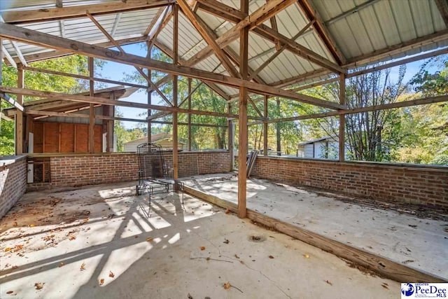 unfurnished sunroom featuring lofted ceiling