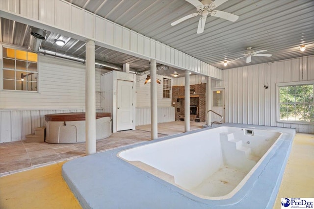 view of pool featuring a hot tub and ceiling fan