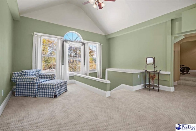 sitting room featuring ceiling fan, carpet flooring, and vaulted ceiling