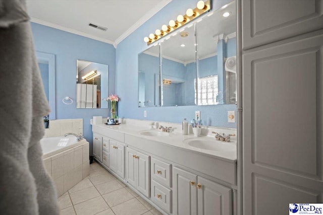 bathroom with vanity, tiled tub, crown molding, and tile patterned floors