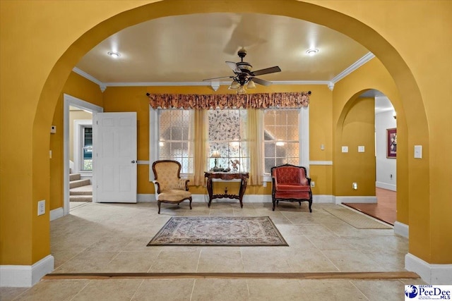 sitting room with ornamental molding and ceiling fan