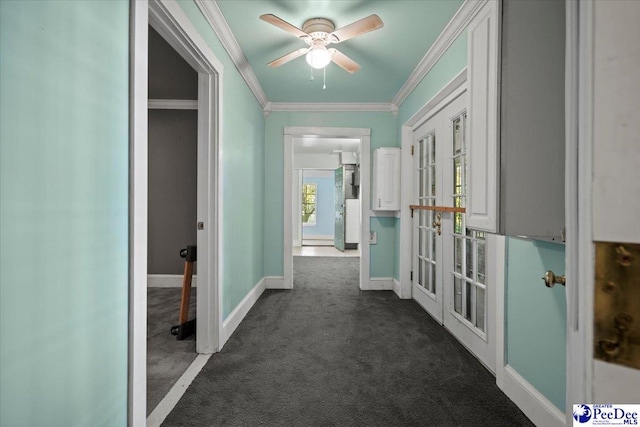 corridor with dark colored carpet, ornamental molding, and french doors