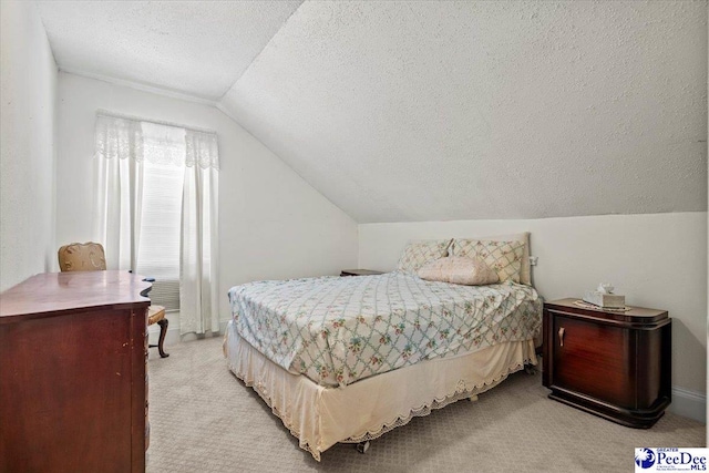 bedroom featuring light carpet, lofted ceiling, and a textured ceiling