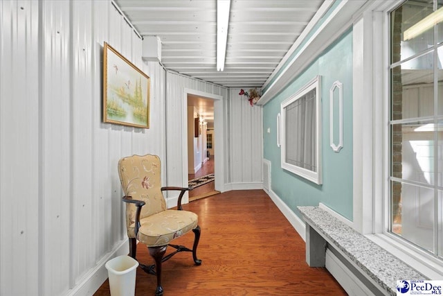 hallway featuring hardwood / wood-style flooring and beamed ceiling