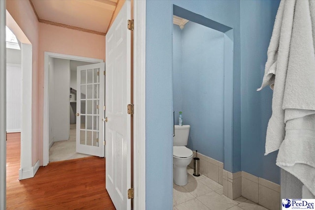 bathroom with wood-type flooring and toilet