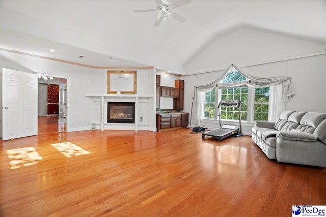 unfurnished living room featuring vaulted ceiling, ceiling fan, and light hardwood / wood-style floors