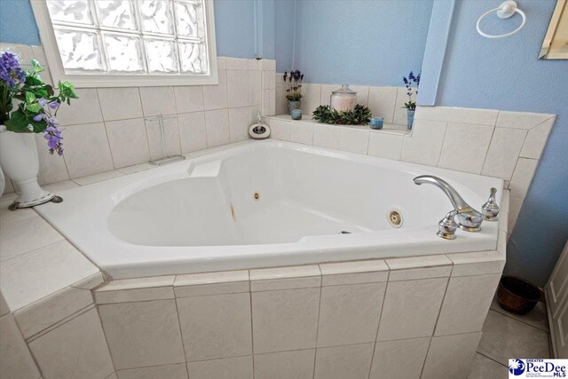 bathroom with a relaxing tiled tub