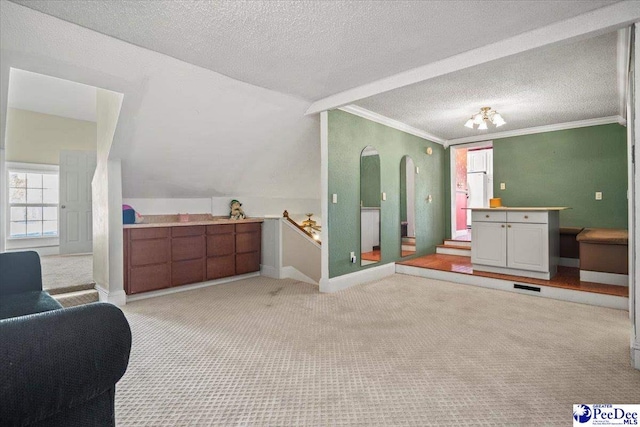 bathroom featuring crown molding, lofted ceiling, and a textured ceiling