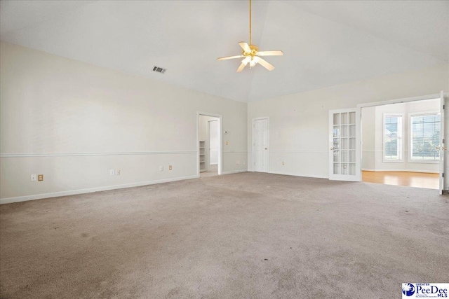 carpeted spare room with high vaulted ceiling, baseboards, visible vents, and a ceiling fan