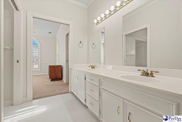 bathroom with double vanity, baseboards, ornamental molding, and a sink