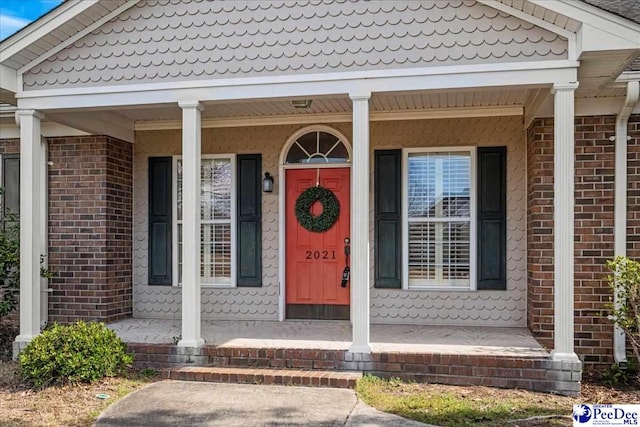 property entrance featuring a porch