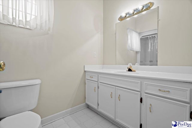 bathroom featuring a shower with curtain, vanity, toilet, and baseboards