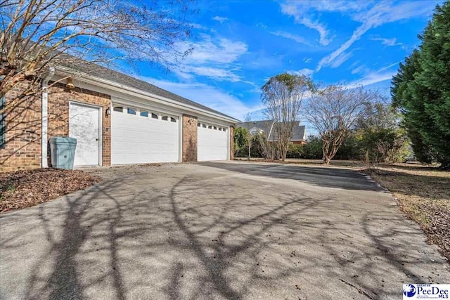 garage with aphalt driveway