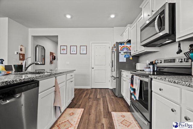 2025 Eastpark Dr, Darlington, SC 29532 - kitchen featuring dark wood finished floors, a sink, light stone countertops, appliances with stainless steel finishes, and white cabinetry