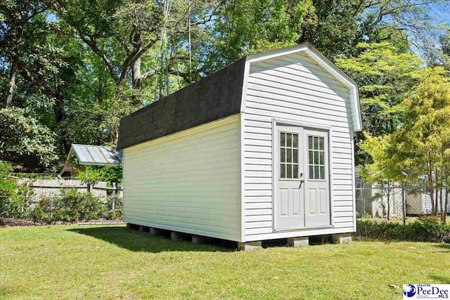 view of shed featuring fence