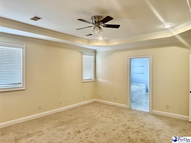 1311 Queens Ferry Rd, Florence, SC 29505 - carpeted empty room featuring a raised ceiling, ornamental molding, ceiling fan, and healthy amount of natural light