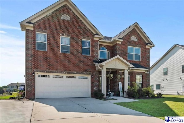 1814 Lake Blalock Dr, Florence, SC 29506 - view of front facade with brick siding, concrete driveway, an attached garage, and a front yard