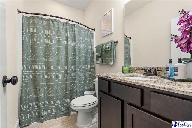 1814 Lake Blalock Dr, Florence, SC 29506 - full bath with toilet, vanity, wood finished floors, and a shower with shower curtain
