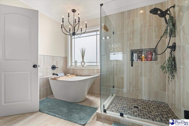 1814 Lake Blalock Dr, Florence, SC 29506 - bathroom featuring a stall shower, a soaking tub, a chandelier, crown molding, and tile walls