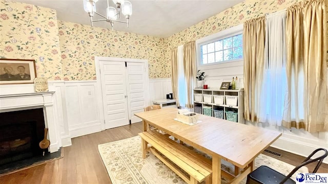 dining room with hardwood / wood-style flooring and a chandelier