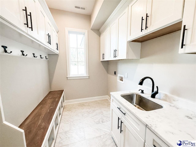 washroom with cabinet space, a sink, marble finish floor, washer hookup, and electric dryer hookup