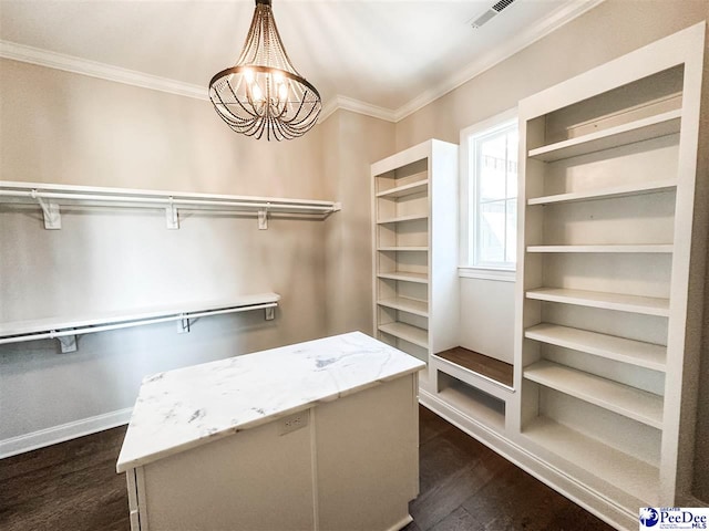 walk in closet featuring dark wood-style floors, visible vents, and a notable chandelier