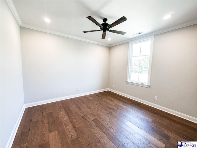 empty room featuring baseboards, visible vents, dark wood-style flooring, and ornamental molding