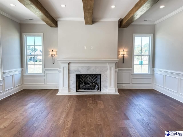 unfurnished living room featuring dark wood-type flooring, beamed ceiling, and a premium fireplace