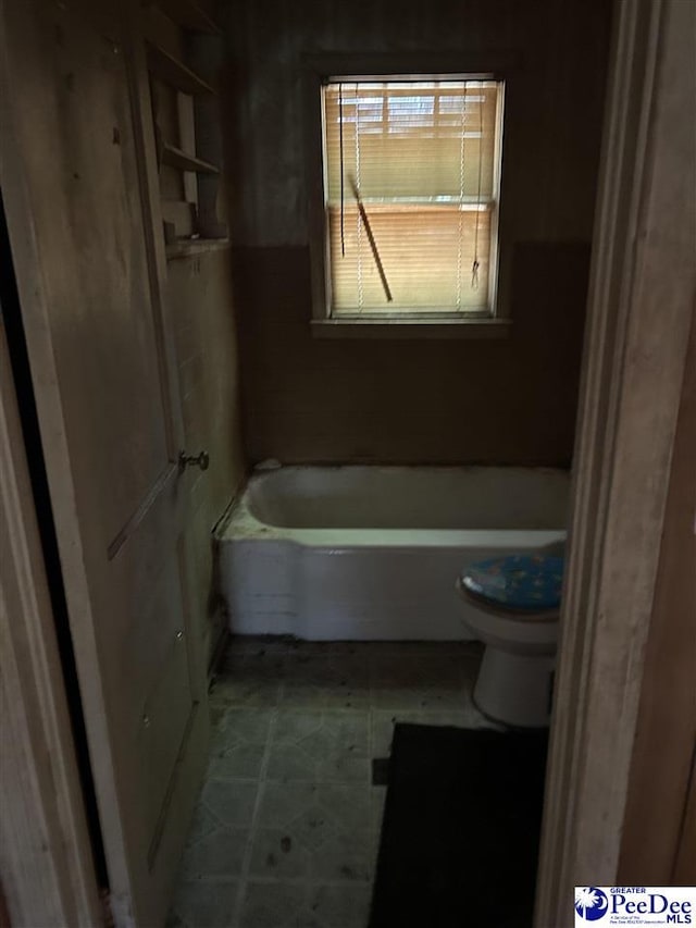 full bathroom featuring a tub and toilet
