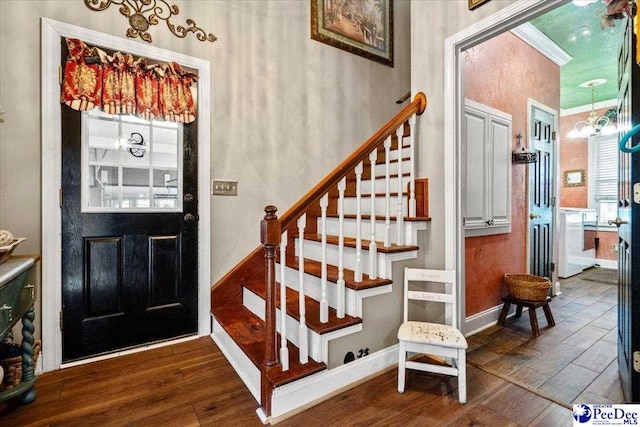 foyer with a notable chandelier and dark hardwood / wood-style flooring