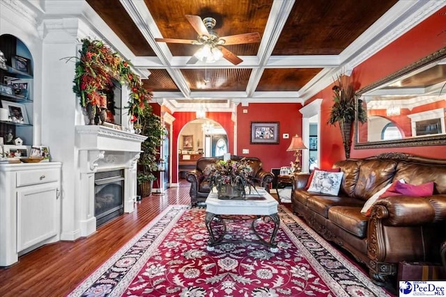 living room featuring coffered ceiling, hardwood / wood-style flooring, crown molding, and ceiling fan