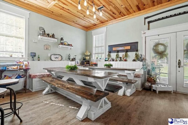 bar featuring hardwood / wood-style floors, crown molding, wooden ceiling, and french doors