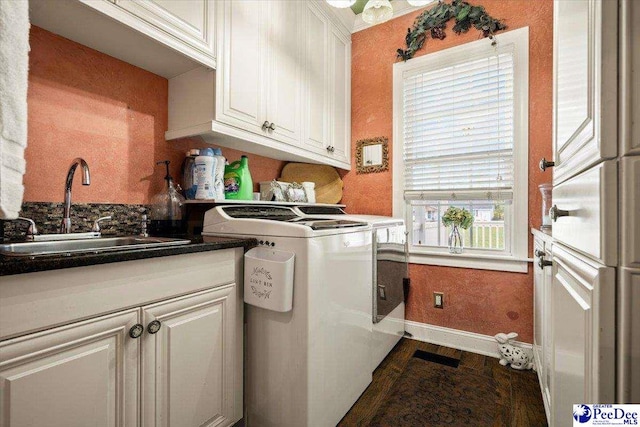 washroom with cabinets, separate washer and dryer, sink, and dark hardwood / wood-style floors