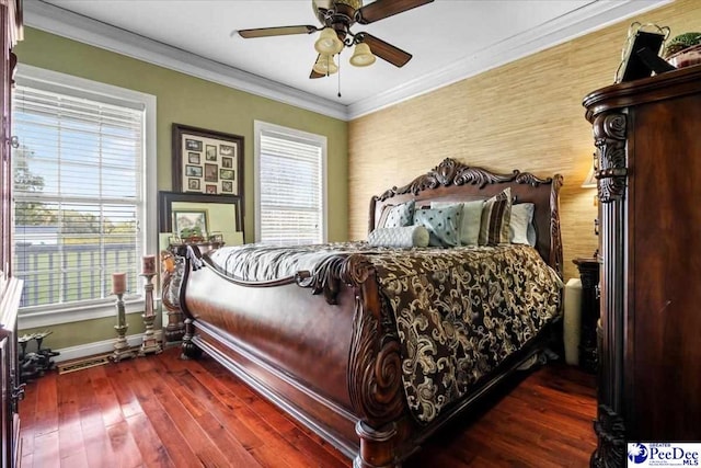 bedroom featuring dark wood-type flooring, ornamental molding, and ceiling fan