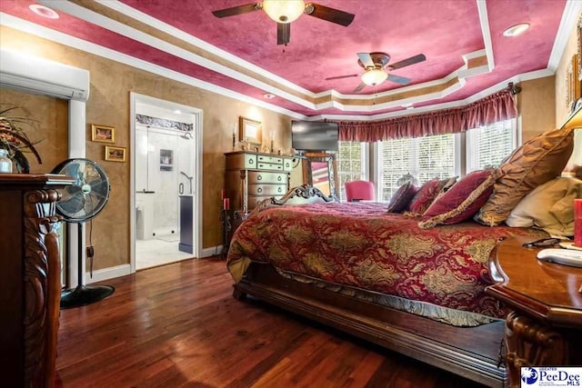 bedroom with dark hardwood / wood-style floors, a wall mounted air conditioner, ceiling fan, a tray ceiling, and crown molding