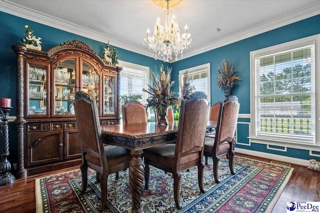 dining area with a notable chandelier, crown molding, and dark hardwood / wood-style floors