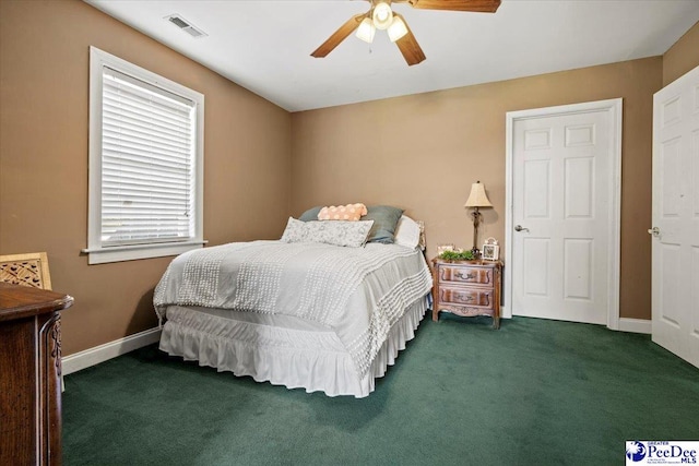 bedroom with ceiling fan and dark colored carpet