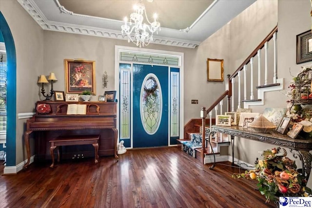 entrance foyer with dark hardwood / wood-style flooring, a wealth of natural light, and a notable chandelier