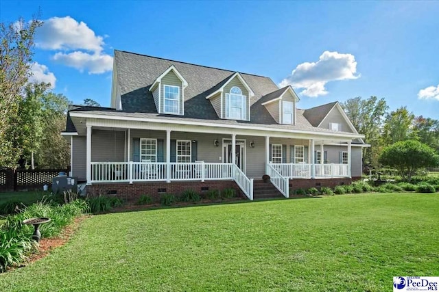 new england style home with a porch and a front lawn