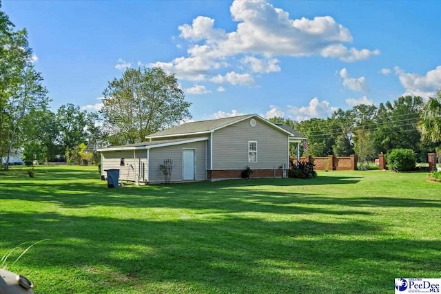 view of outbuilding featuring a lawn