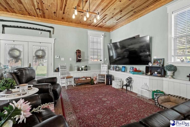 living room featuring crown molding and wood ceiling