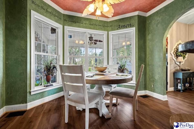 dining space with hardwood / wood-style floors, ornamental molding, and ceiling fan