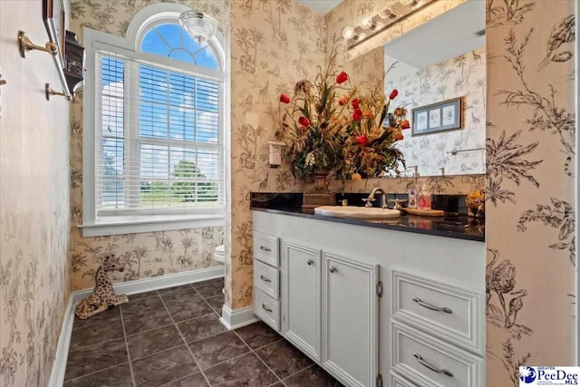 bathroom featuring vanity, toilet, and tile patterned flooring