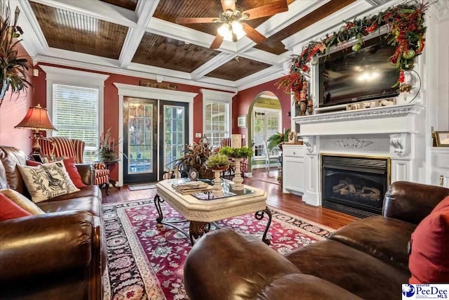 interior space featuring crown molding, hardwood / wood-style flooring, coffered ceiling, and beamed ceiling