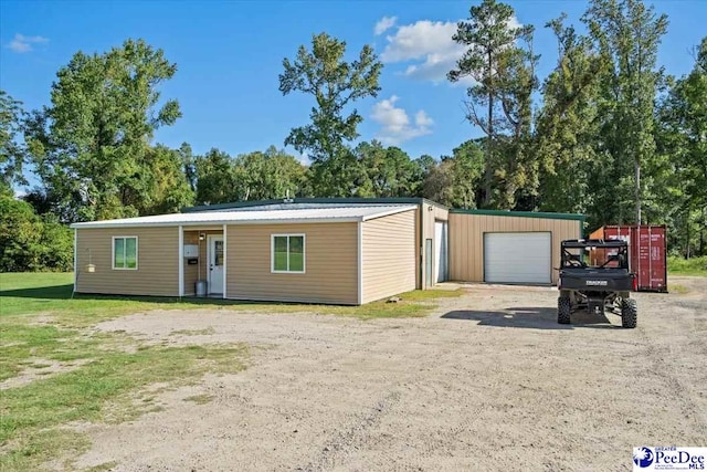 view of front facade featuring an outbuilding and a garage